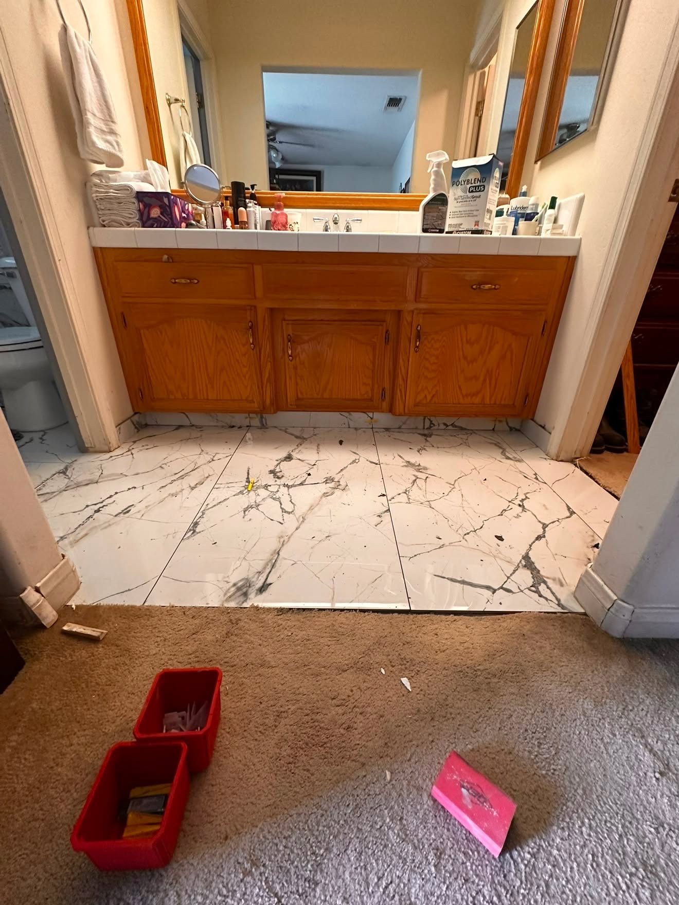 Same bathroom area after new tile flooring installation, clean finished surface