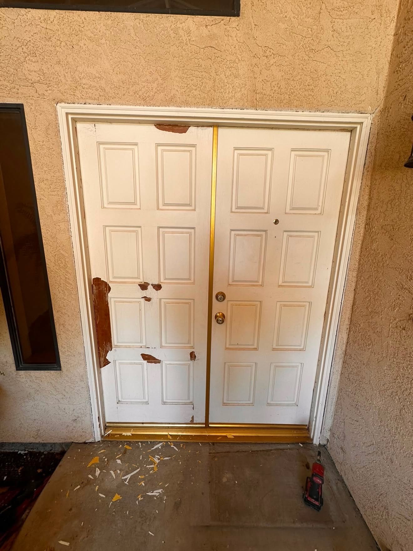 Weathered front entry door with peeling and damaged finish, before repair
